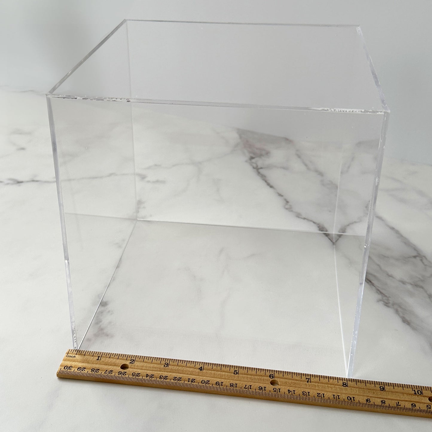 8 inch acrylic cube with ruler showing dimensions