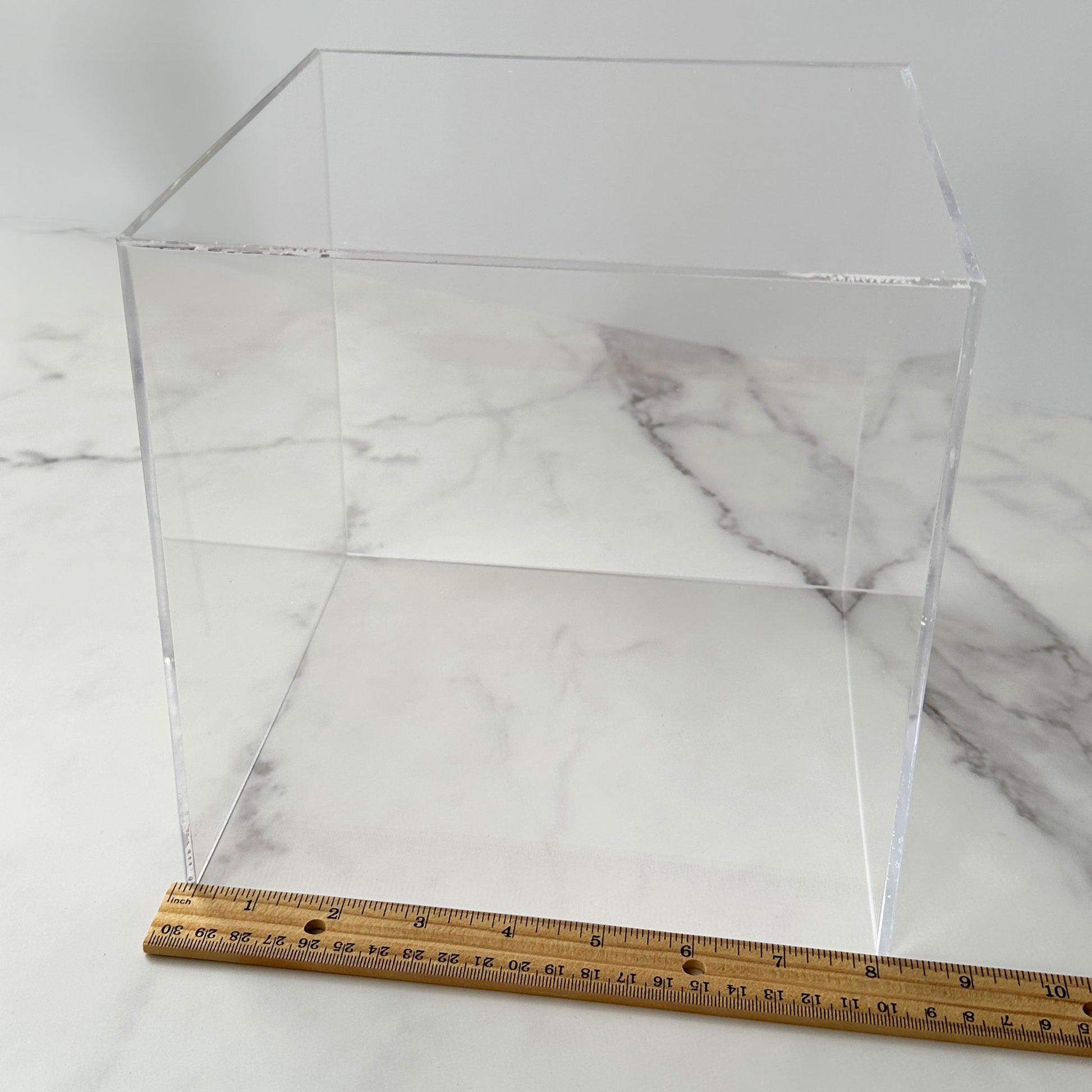 8 inch acrylic cube with ruler showing dimensions